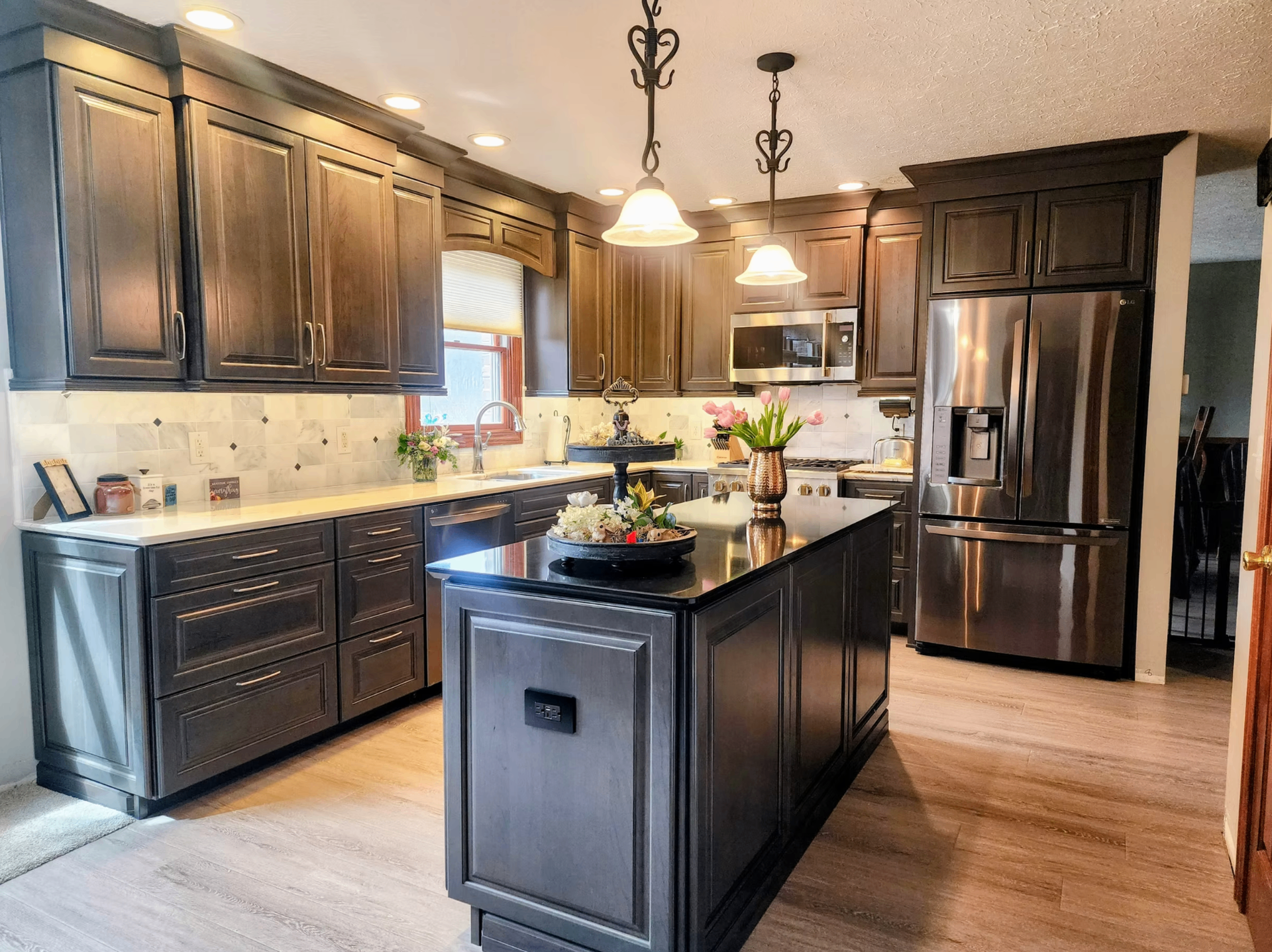 Dark wood island kitchen with painted perimeter cabinets